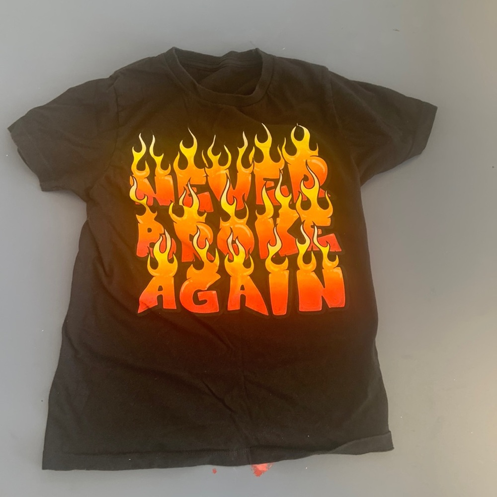 NBA Youngboy “Never Broke Again” Tee. Black and has flaming letters.